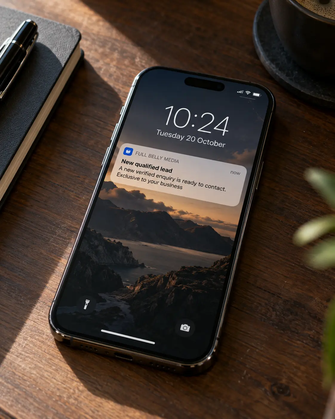 Phone displaying a Full Belly Media notification for a new exclusive qualified lead